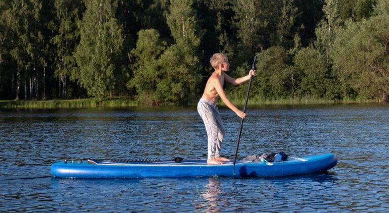 boy on stand up paddle board