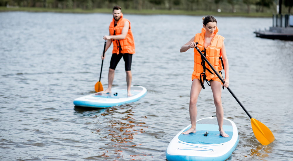 couple rowing on stand up paddleboards